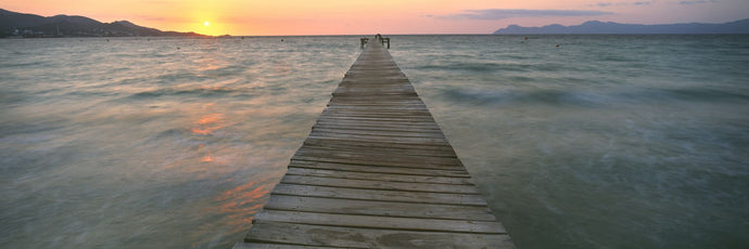 Pier at sunset in the sea, Alcudia, Majorca, Spain