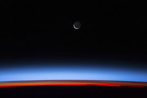 Satellite view of planet Earth showing sunset over Indian Ocean area with crescent moon in the sky