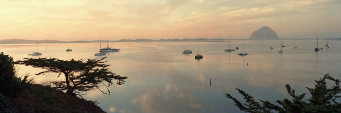 Boats in a bay with Morro Rock in the distance, Morro Bay, San Luis Obispo, California, USA