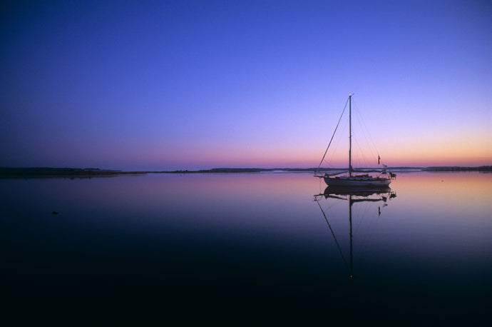 SAILBOAT AT DAWN ON CALM WATER CAMPBELL CREEK NORTHERN CALIFORNIA USA